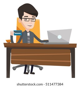 Man Sitting At The Table With Laptop And Holding A Credit Card In Hand. Man Using Laptop For Online Shopping. Man Shopping Online At Home. Vector Flat Design Illustration Isolated On White Background.