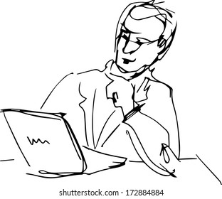 a man sitting at table with laptop reading 