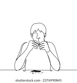 man sitting at the table peeling sunflower seeds to eat - one line art vector. concept of gnawing sunflower seeds, snacks