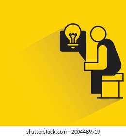 man sitting and thinking idea light bulb icon on yellow background