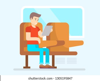 A man is sitting in a train, bus, public transport with a tablet in his hands