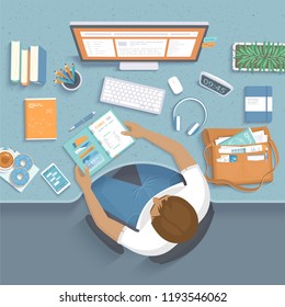 Man sitting at the wooden table. Workplace Desktop Workspace Armchair, office supplies, monitor, books, notebook, headphones, phone, glasses, pen, paper, tea, donuts, bag. Vector Top view 