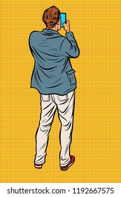 Man with smartphone back. Pop art retro vector illustration vintage kitsch