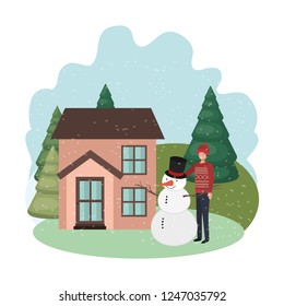 man with snowman and house in winter 
