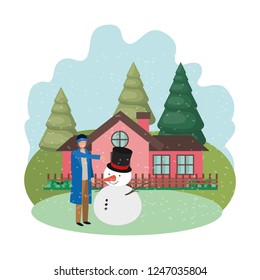 man with snowman and house in winter 
