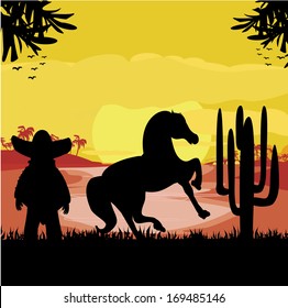 man in a sombrero and his horse in desert sunset
