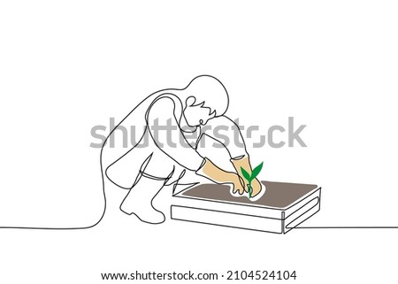 man squatting in front of box of earth and digging green seedling - one line drawing vector. home garden concept, transplant seedlings, plant plant