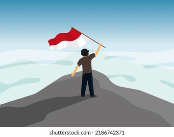 A man stand on the top a mountain waving the Indonesian flag. Flat design vector illustration. Indonesian independence day concept.