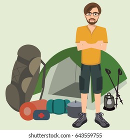 man standing with camping equipment