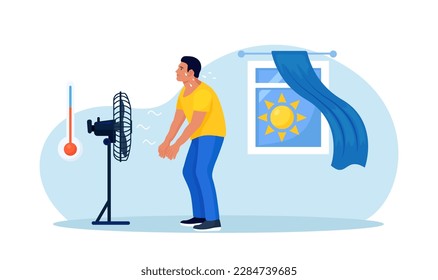 Hombre de pie, enfriándose bajo un ventilador de refrigeración, soplando aire en casa. Temperatura alta, clima caluroso. Verano. Una persona cansada exhausta que sufre de golpes de calor. Sobrecalentamiento y agotamiento. Deshidratación