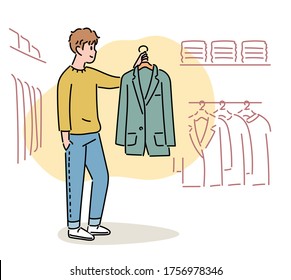 A man is standing in a clothing store holding a jacket. hand drawn style vector design illustrations. 