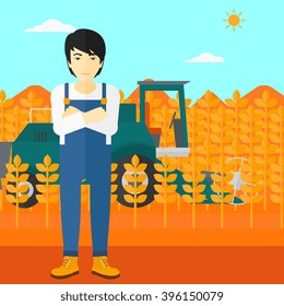 Man standing with combine on background.