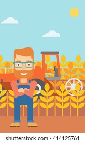 Man standing with combine on background.