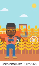 Man standing with combine on background.