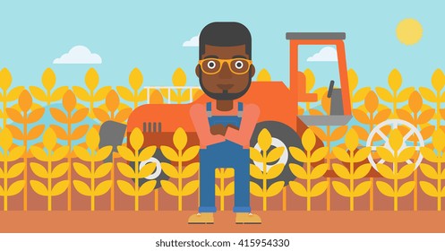 Man standing with combine on background.