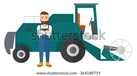Man standing with combine on background.