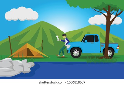 Man standing, drinking coffee against a car with camping have tent, river and mountain.