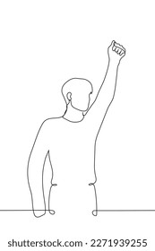 man standing with fist raised up - one line drawing vector. concept gesture of triumph, victory, fist up