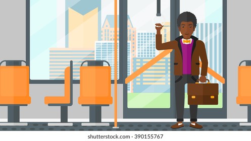 Man standing inside public transport.