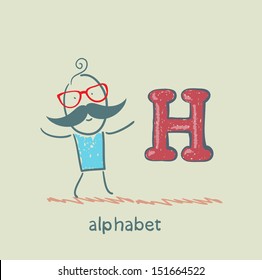 man standing with a letter of the alphabet