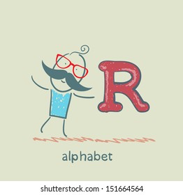 man standing with a letter of the alphabet