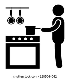 Man standing and making something in saucepan depicting home kitchen