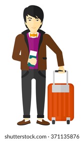 Man standing with suitcase and holding ticket.