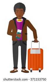 Man standing with suitcase and holding ticket.