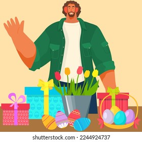 Man standing waving with his hand next to table with Easter eggs, gifts and flowers in pot. Happy Easter concept. Lovely spring holiday and tradition attributes, colorful eggs in basket and tulips