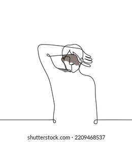 man stands closing himself from bright light and covering his eyes with his hand - one line drawing vector