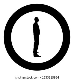 Man stands dressed in work clothes overalls and looks straight icon black color vector in circle round illustration flat style simple image