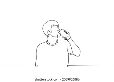 Man Stands And Drinks Beer, Energy Drink Or Soda From Aluminum Can - One Line Drawing Vector. Concept Of Drinking Alcohol Or Unhealthy Sweet Drinks