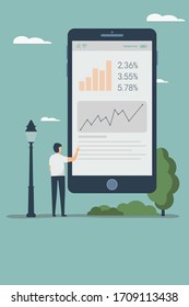 A man stands in front of a huge mobile screen and clicks on it
