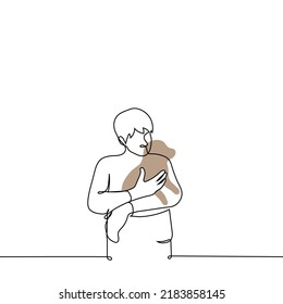 man stands holding a puppy in his arms - one line drawing vector. the concept of a dog lover, the owner of the dog lovingly holds and cuddles the pet