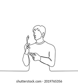 man stands looking at burning match in his hand  and the other hand holding box matches    one line drawing  combustion process concept  pyromaniac 