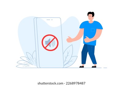 A man stands near the smartphone, on the screen no sound sign. Forbidden sign with loudspeaker