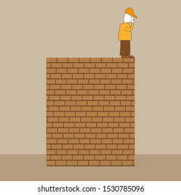 A man stands on the edge of a brick wall and looks down