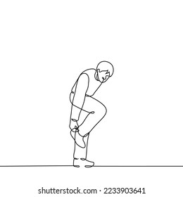 man stands one leg straightening the bottom his pants    one line drawing vector  concept hurry   adjust clothes the go  uncomfortable shoes