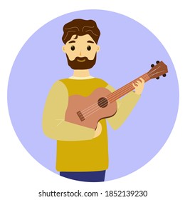 A man stands and plays the guitar