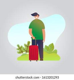 A man stands while carrying his suitcase. Travel concept design
