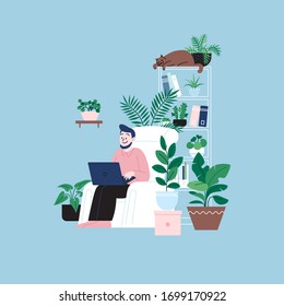 A man staying home working on the laptop sitting in the chair. A room full of plants.