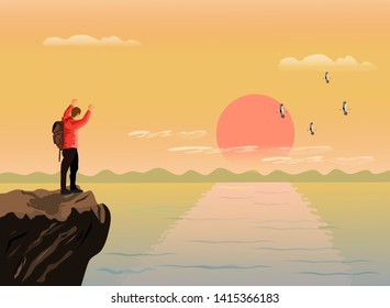 The man stood up and showed his hands on the top of the mountain happily. There are sea, mountains and sunset background