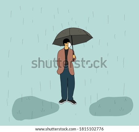Man or student wearing face mask and using umbrella Preventing Covid-19 Coronavirus Pandemic Outbreak Outdoors.Rainy Weather under Umbrella at Fall Sesons