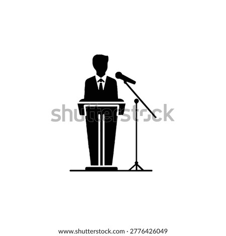 Man in suit speaking at microphone