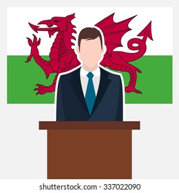 Man in suit standing at rostrum Front of Wales Country Flag. business man Presentation conference concept. Modern flat design vector illustration. Country Flag background