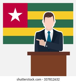 Man in suit standing at rostrum Front of Togo Country Flag Pointing to the flag. Business man Presentation conference concept. Modern flat design vector background.