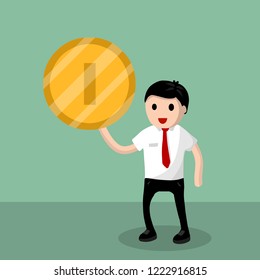 A man in a suit with a tie holding a huge gold coin. Office worker and financial Bank investments. Business operation.
