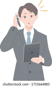 A man in a suit who found a surprising fact on the phone, the version with a tablet