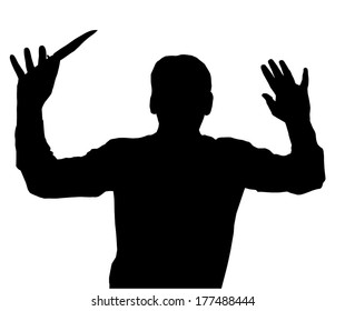 Man surrendering while holding knife in one hand