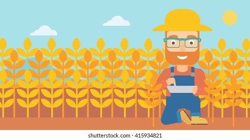 Man with tablet computer on field.